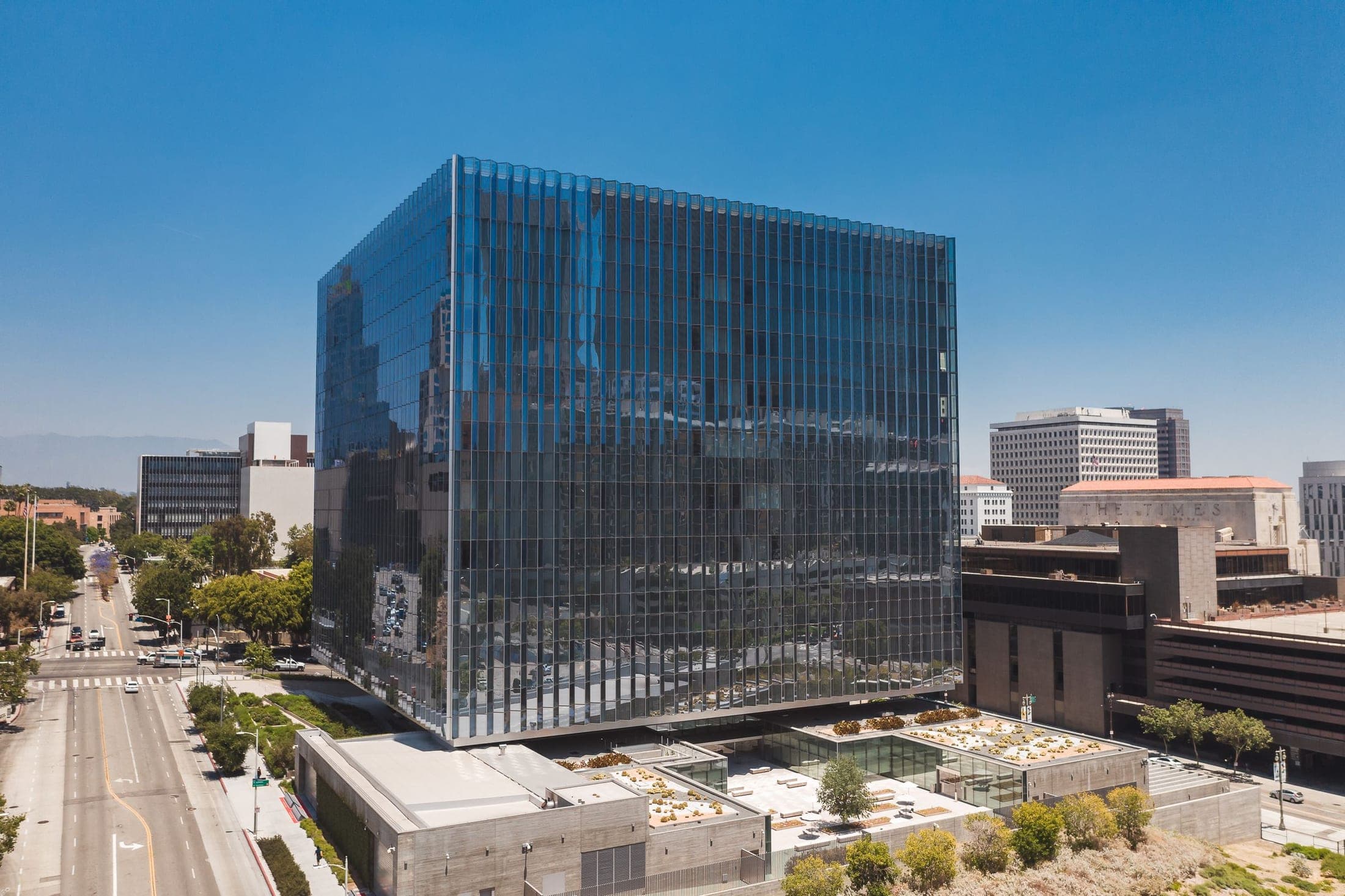 A glass-clad federal courthouse reflecting the sky above downtown Los Angeles